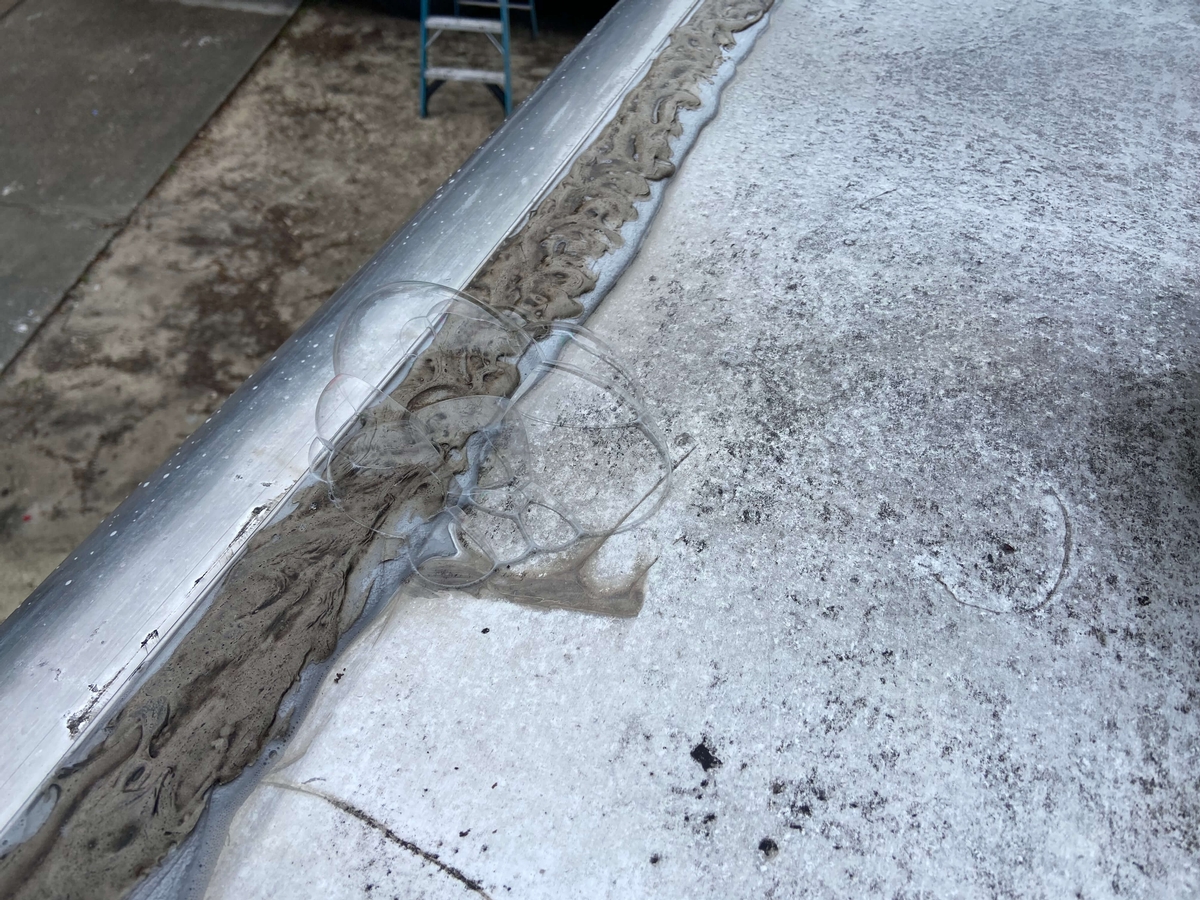 RV roof that is leaking through old weakened caulk.